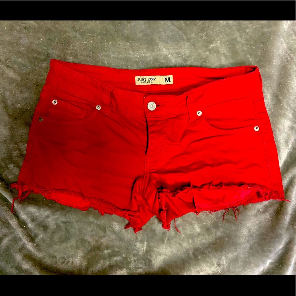 Red distressed booty shorts